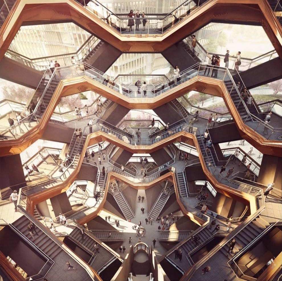 A rendering of <i>Vessel</i> shows the view from the top of the structure, looking down at a maze of interconnected stairwells. People talk and climb on the various paths. The underside of each set of stairs is polished copper-colored steel.